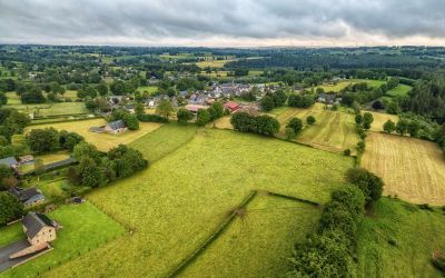 Aerial view of the green Belgian countryside with a village