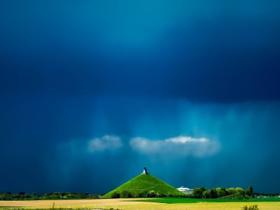The Lion&rsquo;s Mound of Waterloo under a stormy sky